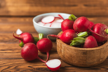 Fresh radish on textured wooden background. Organic natural garden radish slices. clipping root crop. Vegetables. Vegan. Diet products. Healthy food. Place for text. Copy space.