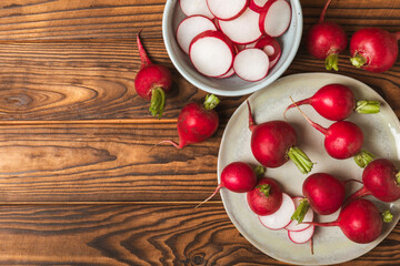 Fresh radish on textured wooden background. Organic natural garden radish slices. clipping root crop. Vegetables. Vegan. Diet products. Healthy food. Place for text. Copy space.