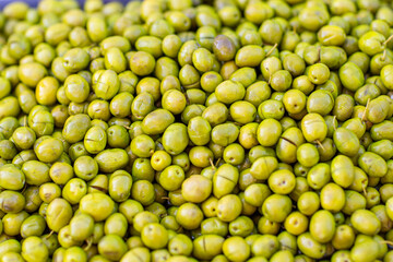 Green olives at the local market Selective focus. full-screen background close-up