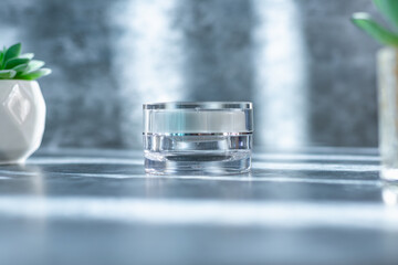 clear cream jar on the grey surface with overlay shadow, use for beauty mockup product