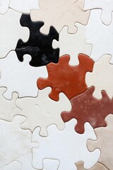 Obraz premium A jigsaw puzzle made of white and brown pieces. The puzzle is made up of many pieces, and the colors are varied. The image has a playful and creative mood