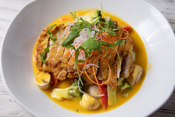 Asian fried chicken with vegetables and rice served on plate. 