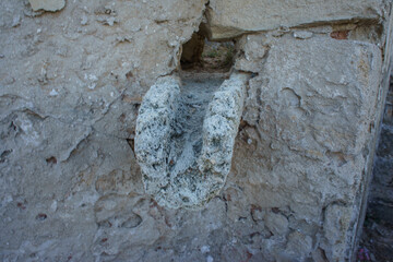 Ancient stone carving in a weathered wall, depicting artistic craftsmanship from a bygone era.