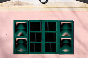green window in the pink wall