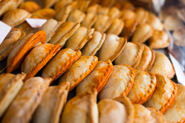 Freshly baked empanadas with different fillings for sale