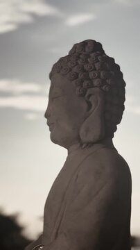 Statue of Budha with soft rays of sunlight.
