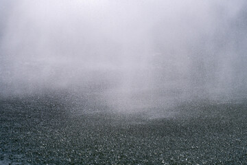 water drops sprayed from the fountain on the pond