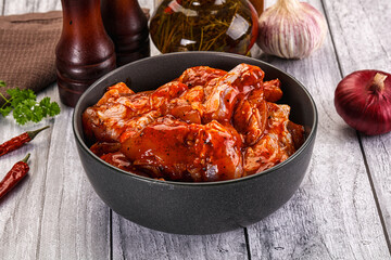 Raw marinated buffalo chicken wings