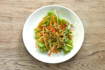 spicy and sour sea horseshoe crab egg wiith slice vegetable salad Thai food on plate