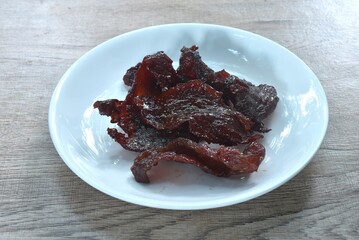 salty and sweet dry fried slice beef meat fermenting in sesame oil and pepper on plate