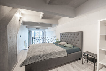 Wide Angle of Loft Home Bedroom Interiom. King Size Double Bed. White Walls. Family Home.