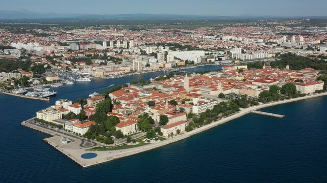 Aerial shot of Zadar old town, famous tourist attraction in Croatia. Waterfront aerial summer view, Dalmatia region of Croatia. Drone, 4k.