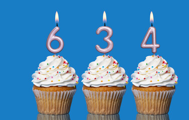 Birthday Cupcakes With Candles Lit Forming The Number 634