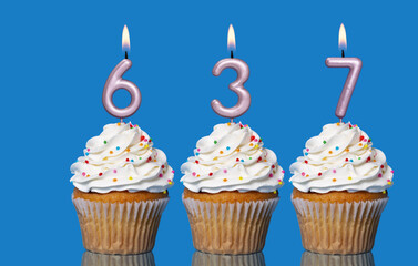 Birthday Cupcakes With Candles Lit Forming The Number 637