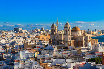 Aerial panoramic view of the old city rooftops and Cathedral de Santa Cruz from tower Tavira in Cadiz, Andalusia, Spain © olyasolodenko