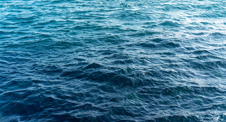 Blue ocean water with gentle ripples and waves, capturing natural texture and movement of sea surface
