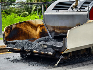 Asphalt paving machine laying down asphalt