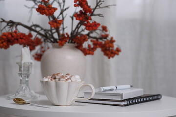 A Cozy Coffee Setup Featuring Beautiful Autumn Decor, Notebooks, and a Relaxing Atmosphere