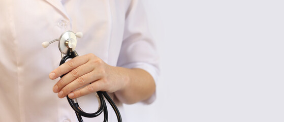 Doctor or nurse with stethoscope in hand. Medicine and health concept. Pediatrician in white coat...