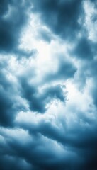 Obraz premium Dark, moody clouds swirl in a dramatic sky, creating an atmospheric and slightly ominous backdrop.