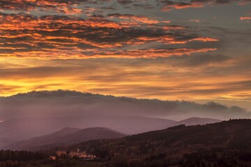 Sunset captured with colored clouds and orange sky.