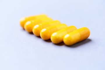 Vitamin C capsules. Bright background. Close up. Copy space.