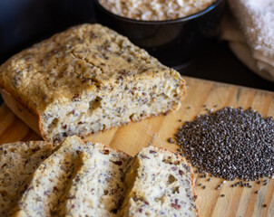 Slices of organic bread with flax and chia seeds in a rustic farm kitchen