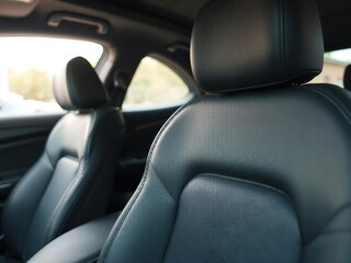 Close-up of luxurious leather car seat with blurred car interior in the background, luxury, leather