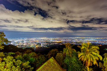 High angle view background from the mountain, showing the lights of apartment buildings, houses,...