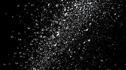Obraz premium White water droplets falling on black background, creating a splash and abstract pattern.