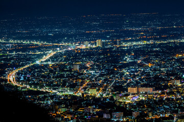 High angle view background from the mountain, showing the lights of apartment buildings, houses,...