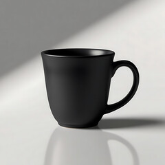 Minimalist black ceramic mug on a white surface, perfect for product mockups.