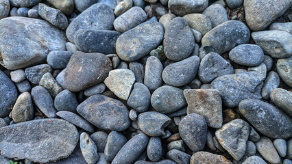 Crushed grey stone on the ground texture background, Crushed rock close up, Crushed stone road building material gravel texture. Selective Focus