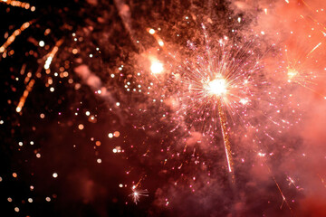 Fototapeta premium Brilliant fireworks display lights up the night sky with vibrant bursts of color and dazzling sparkles, creating a mesmerizing and festive atmosphere.