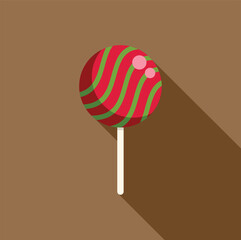 Round lollipop with red and green swirl pattern casting a long shadow on a simple brown background