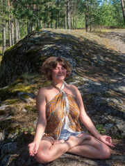 woman sitting in forest in summer