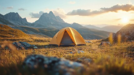 Bright yellow tourist tent at a height in the mountains. Dawn in the mountains. The concept of mountain climbing tourism.