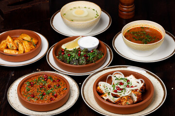 Assorted traditional Georgian cuisine on a black wooden table