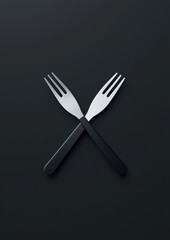 Fototapeta premium Two forks are crossed over each other on a black background