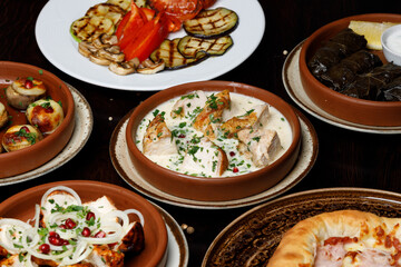 Assorted traditional Georgian cuisine on a black wooden table