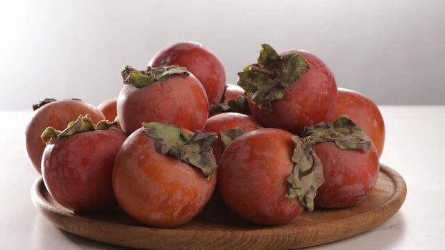 harvest of ripe persimmon on plate chocolate kinglet food