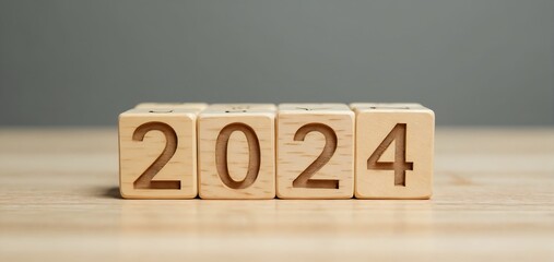 Wooden blocks displaying the year 2024 on a neutral background, suggesting the arrival of a new year