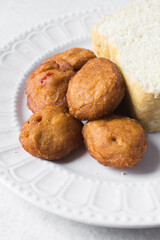 Overhead view of Akara on a white plate, top view of nigerian akara fried beans cake on a plate
