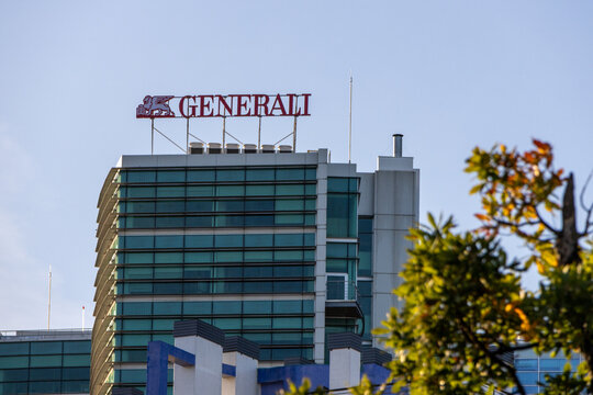 Generali tower with clear blue sky and tree branches in foreground
