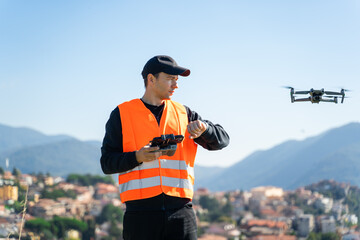Naklejka premium Young man with modern drone in mountains, back view