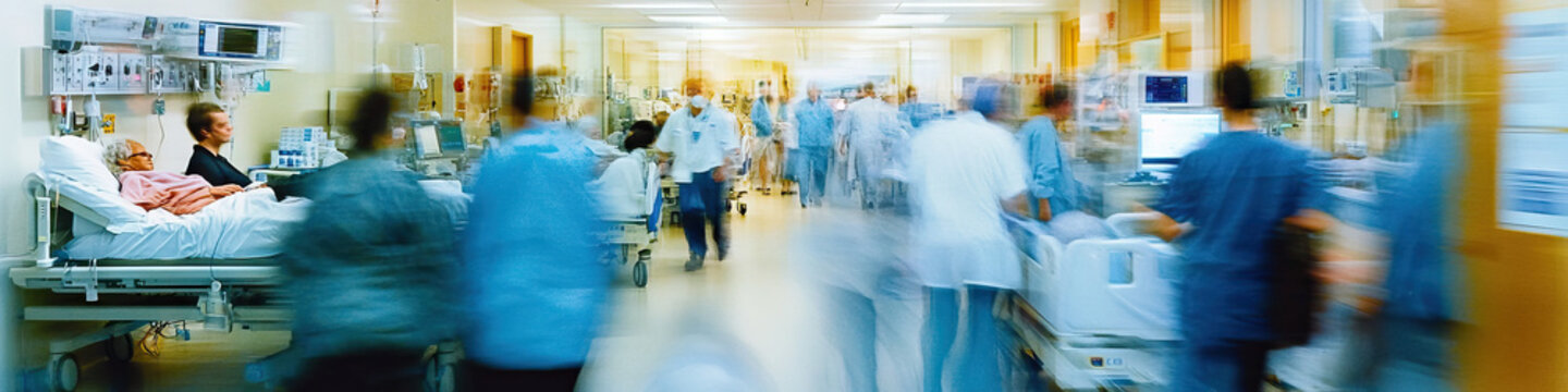 A chaotic close-up of a hospital ward, with staff bustling about and patients in various states of distress.