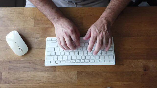 Typing on white computer keyboard