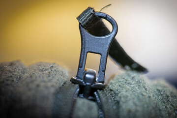 zipper on an old green jacket.
