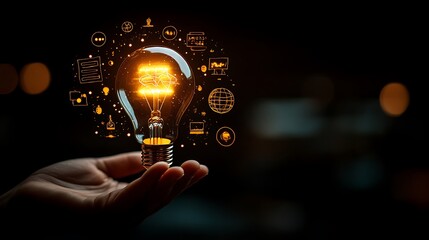Hand holding an illuminated light bulb with digital icons, Business idea light bulb with technology icon