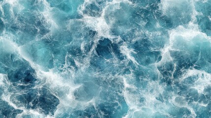 Obraz premium A close-up view of the ocean's surface, showing the turquoise blue water and white foam created by the waves.